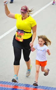 My daughter and I crossing the finish line at my first 10 mile event