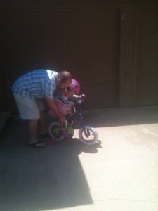Kylie, and her dad, learning how to ride her first bike