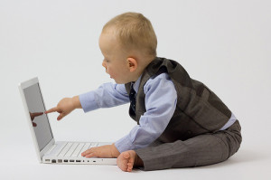 Baby touching a laptop by Paul Inkles/Flickr available through CC BY 2.0