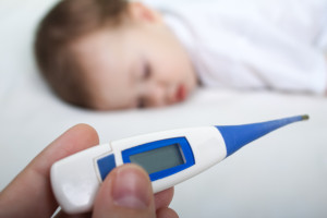 Sick child with thermometer