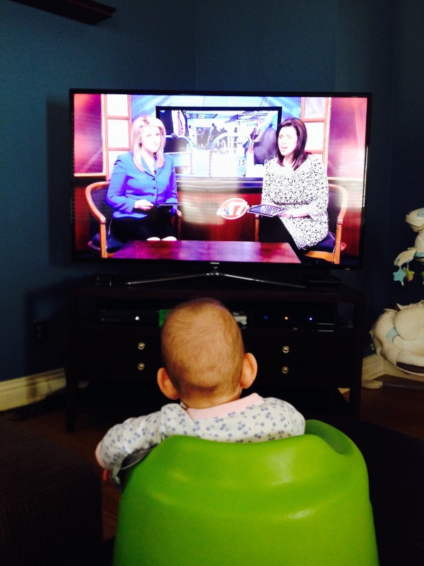 Peyton watching Mommy on the news.