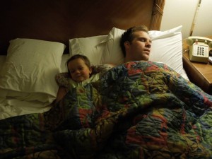 Dad and baby resting in motel room