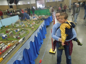 Gabriel and Miri looking at a model train layout at an expo