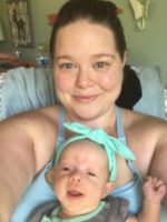mom and baby NICU preemie hospital stay hand to hold