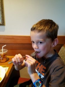 Boy eating macaroni, micropreemie, NICU, feeding delays