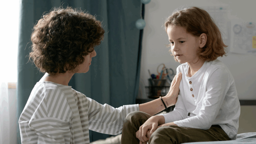 mom comforts child about a sibling in the NICU,