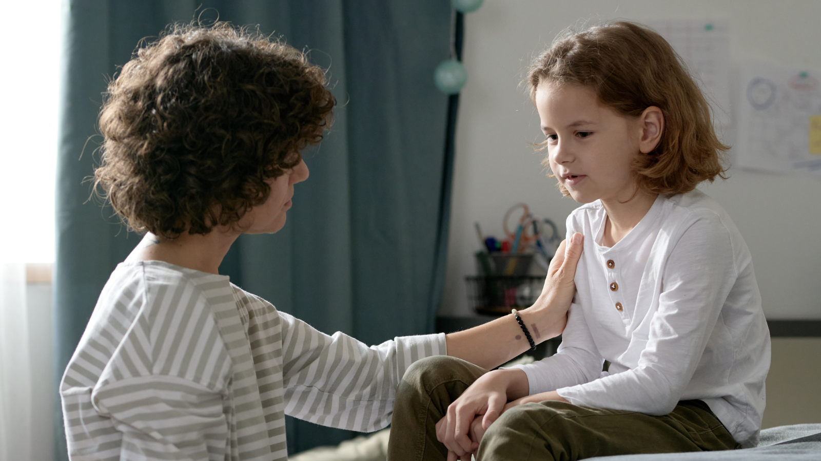 mom comforts child about a sibling in the NICU,